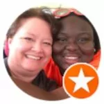 Two women posing for a photo with an orange star.