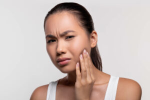 Asian woman having toothache