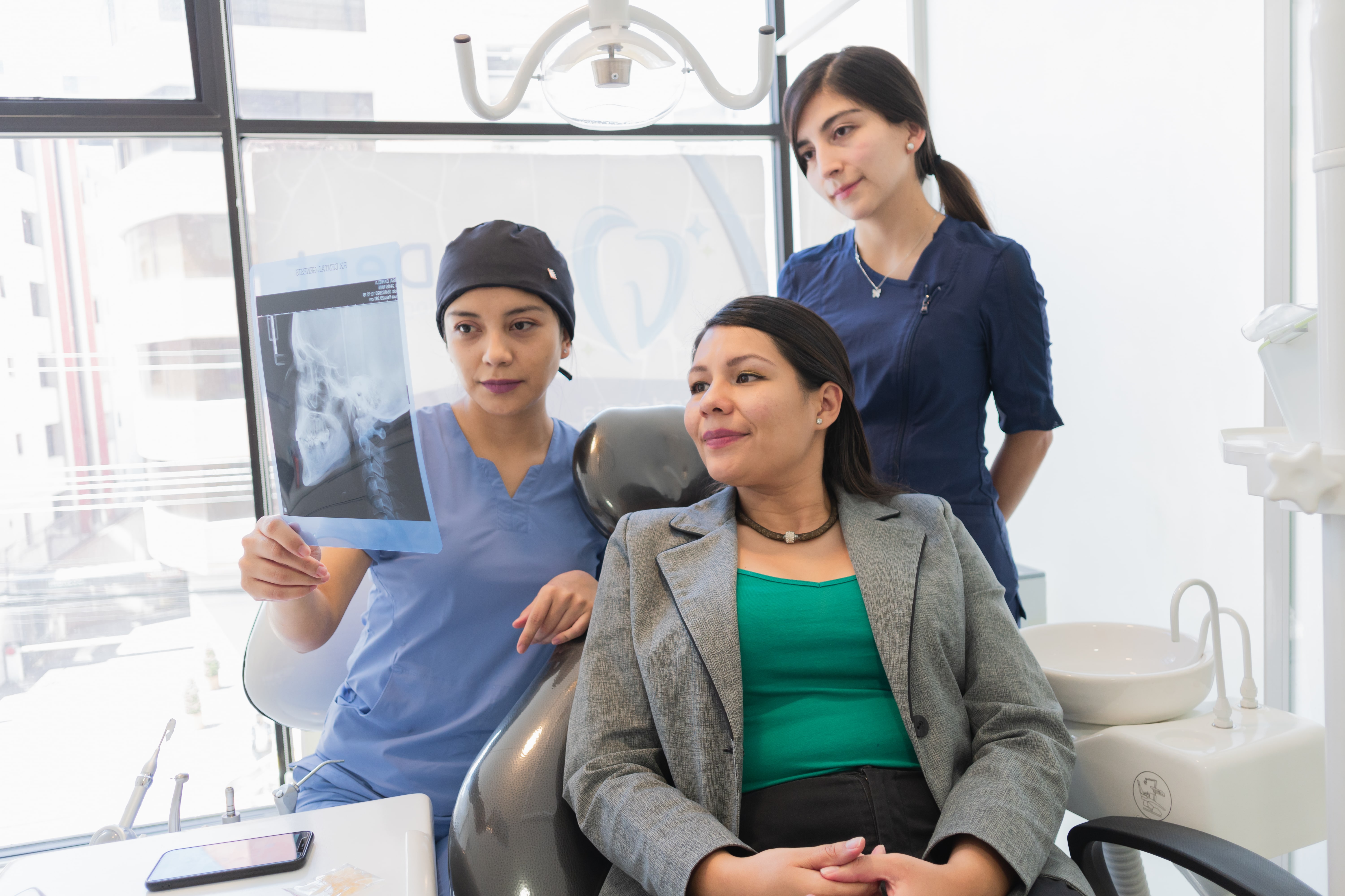 dentist with patient showing x-ray tmj